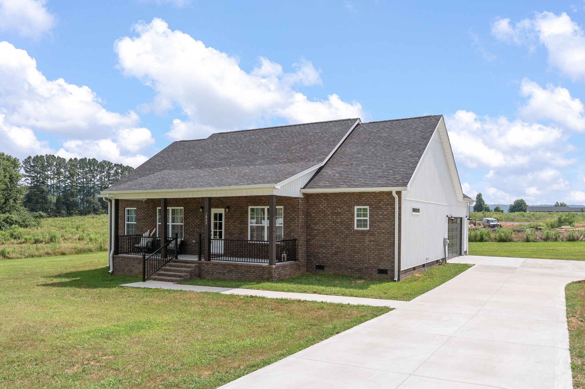 a view of a house with pool and a yard