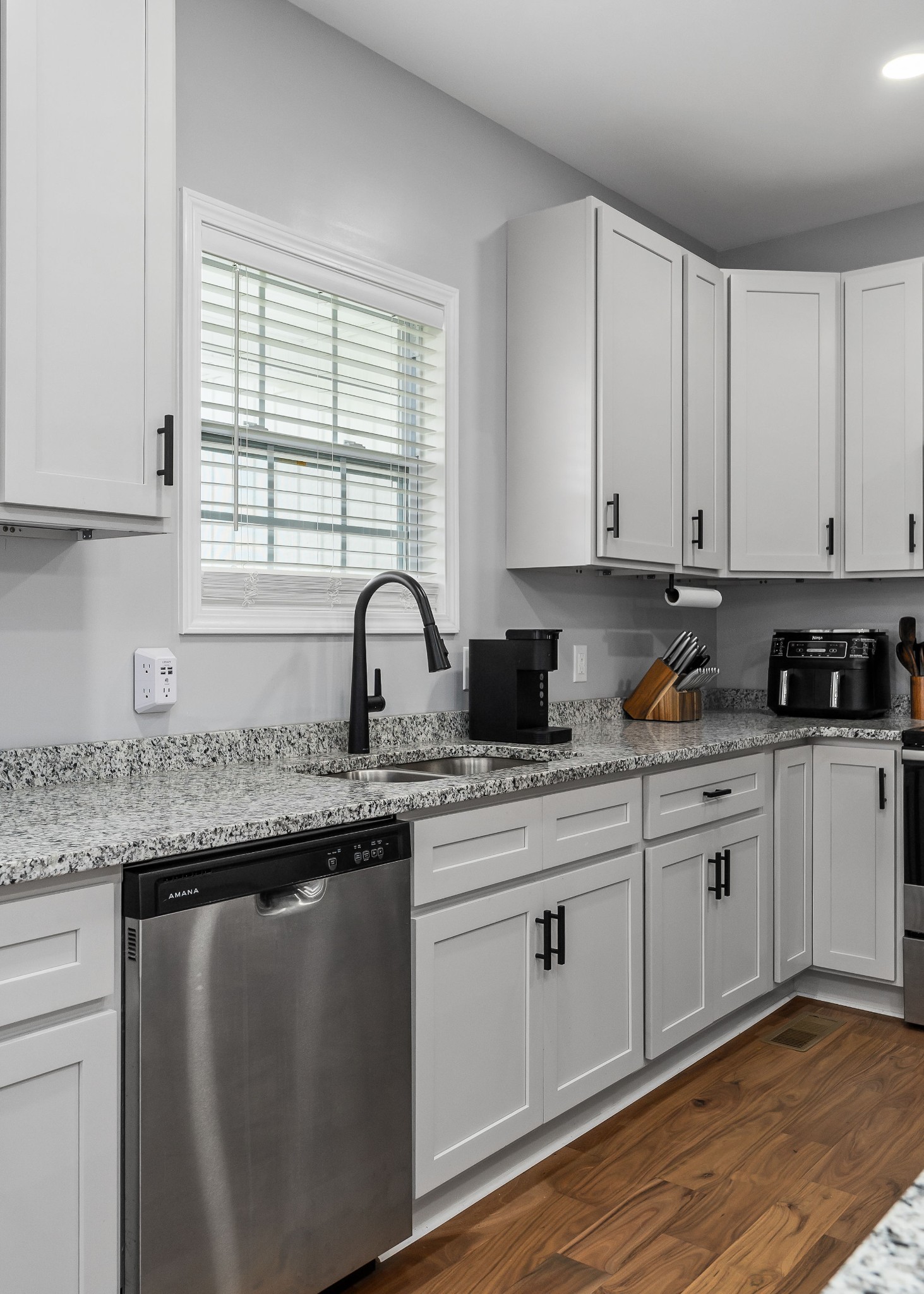 1042 North Spring Street Sparta, TN 38583 - Photo 13 of 36 a kitchen with granite countertop white cabinets and white appliances