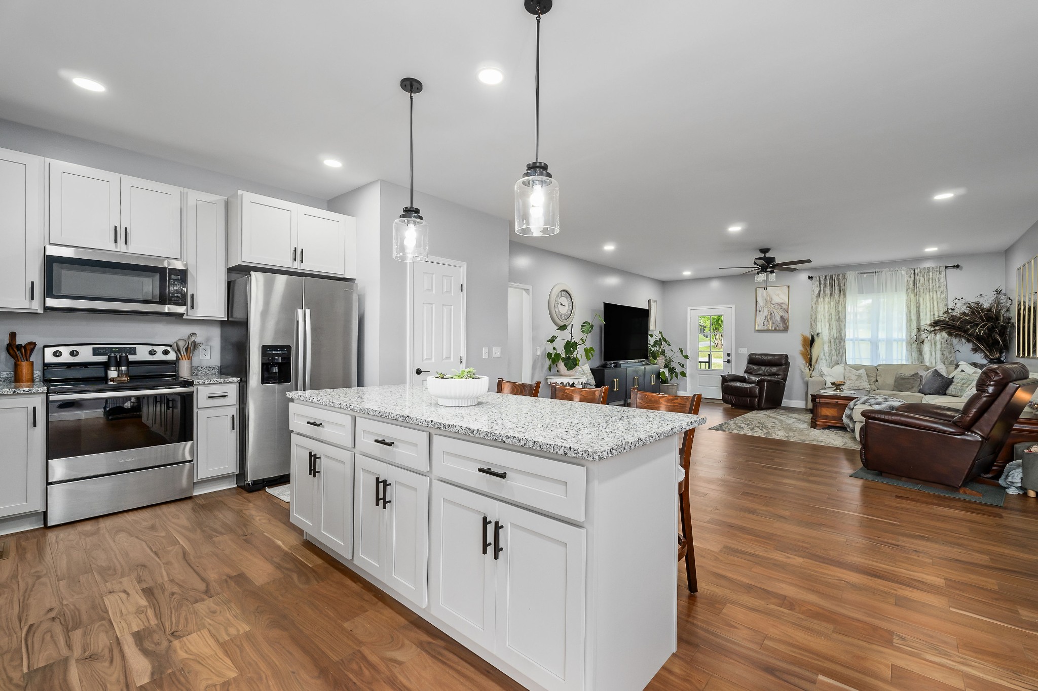 1042 North Spring Street Sparta, TN 38583 - Photo 14 of 36 a kitchen with stainless steel appliances kitchen island granite countertop a stove and a refrigerator