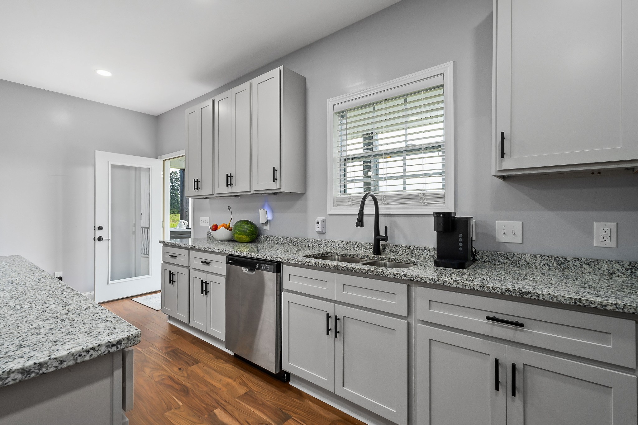 1042 North Spring Street Sparta, TN 38583 - Photo 15 of 36 a kitchen with granite countertop white cabinets and white appliances