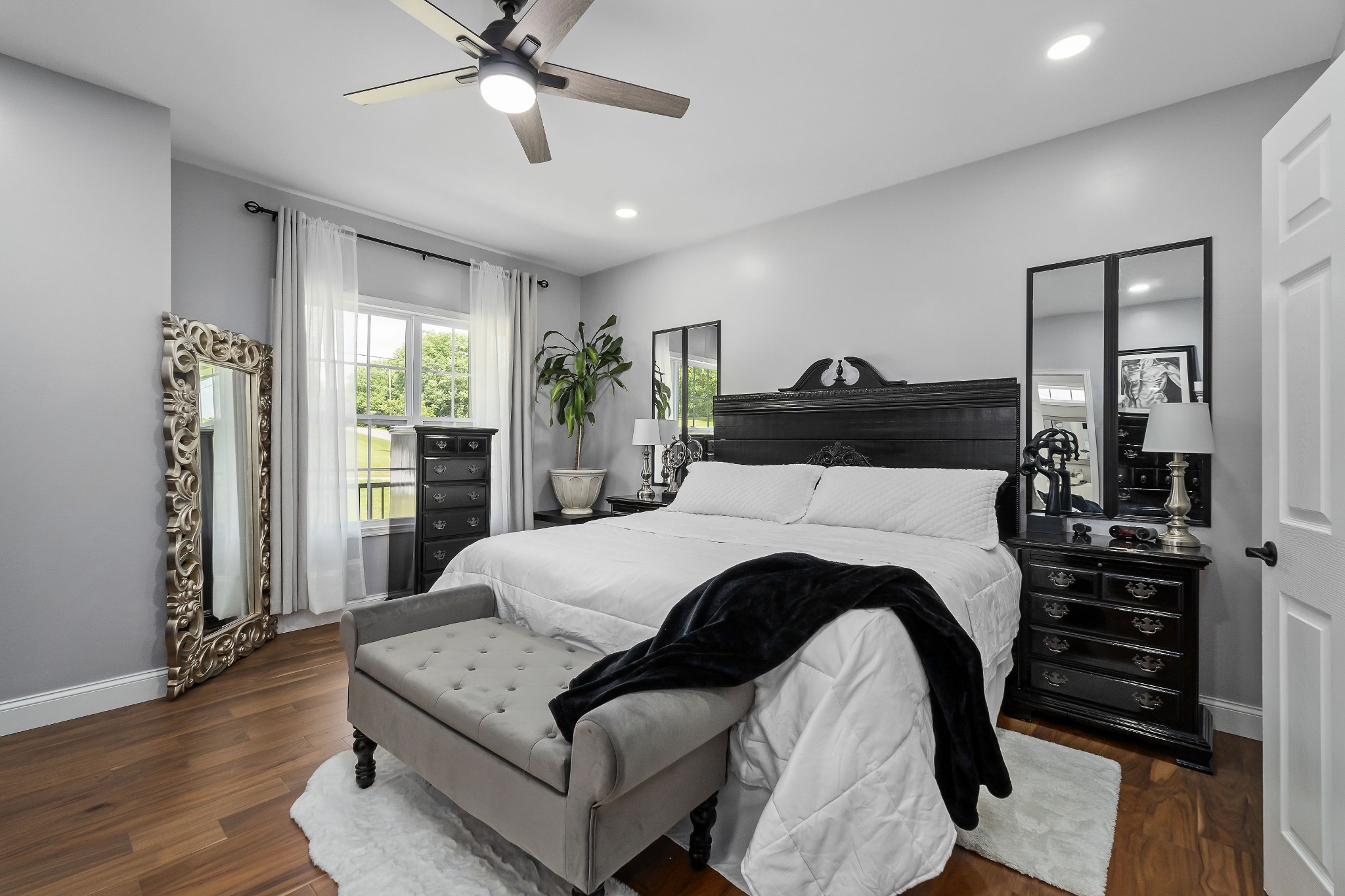 1042 North Spring Street Sparta, TN 38583 - Photo 20 of 36 a spacious bedroom with a bed and a chandelier