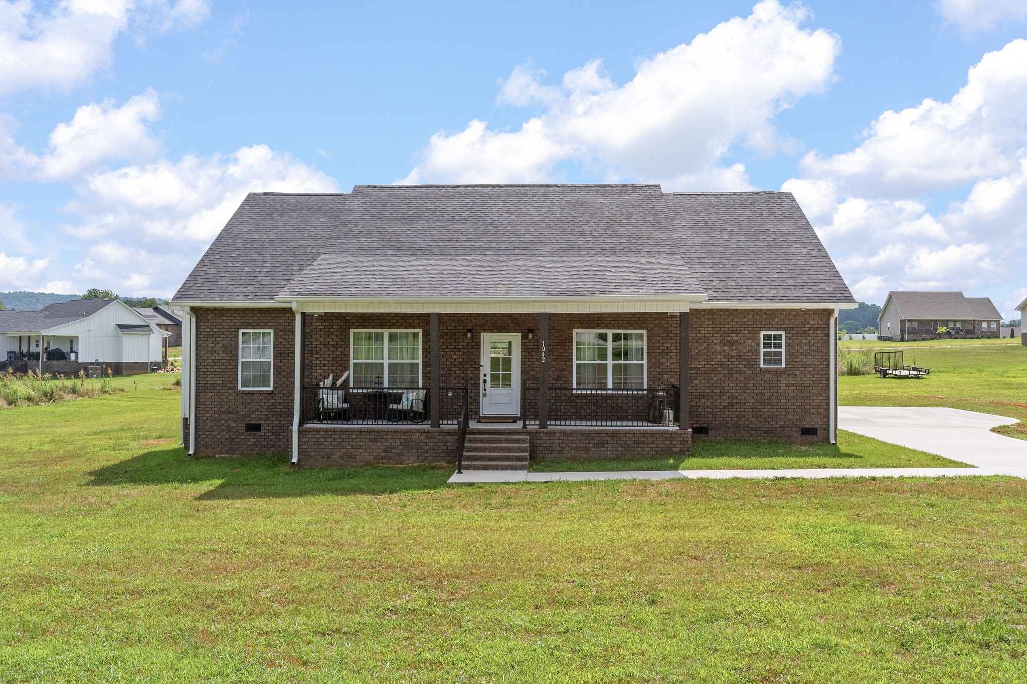 1042 North Spring Street Sparta, TN 38583 - Photo 2 of 36 a view of a brick house with a yard
