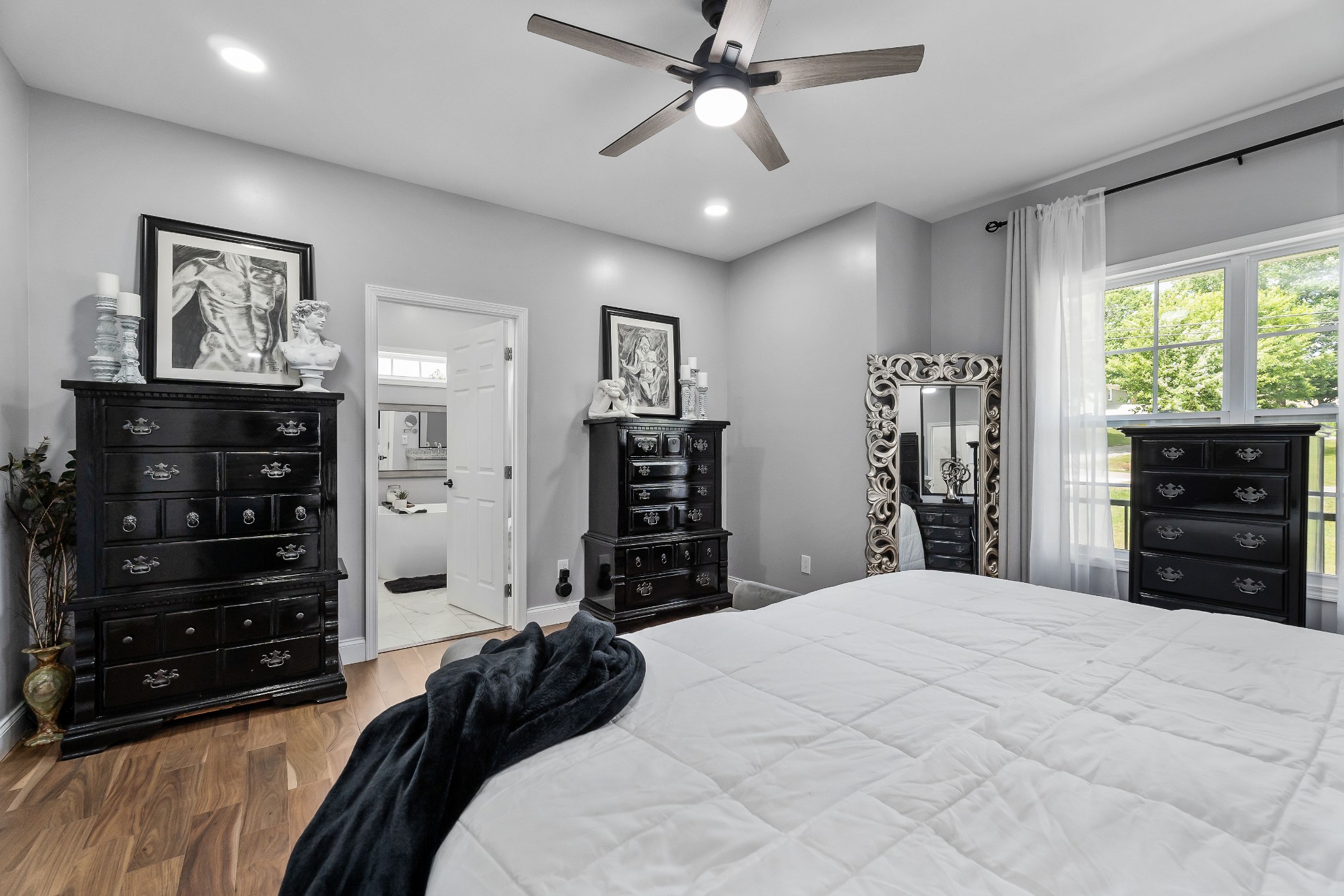 1042 North Spring Street Sparta, TN 38583 - Photo 21 of 36 a bedroom with a bed a lamp and a large mirror