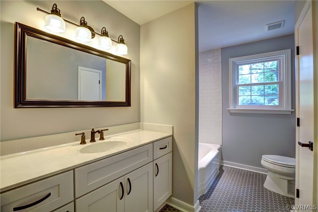 10125 Merrimac Road Richmond, VA 23235 - Photo 25 of 25 a bathroom with a toilet sink and mirror