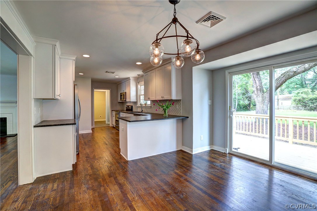 10125 Merrimac Road Richmond, VA 23235 - Photo 9 of 25 a view of a kitchen with wooden floor and a window