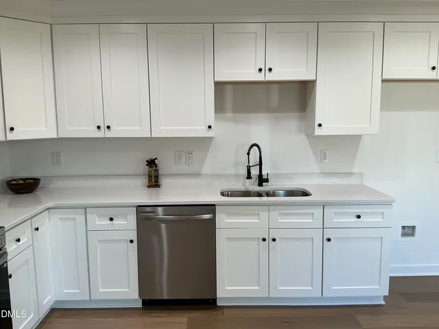 a kitchen with white cabinets and a sink