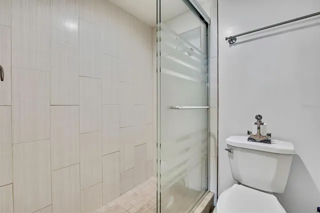 a bathroom with a toilet and a shower