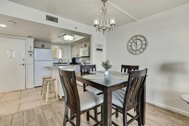 a view of a dining room with furniture and a chandelier