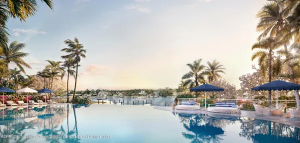 a view of a lake with a table and chairs under an umbrella