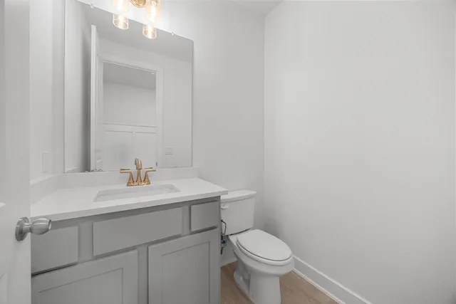 a bathroom with a sink a toilet and mirror