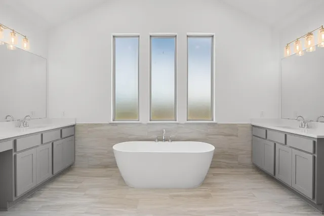 a spacious bathroom with a double vanity sink and a mirror