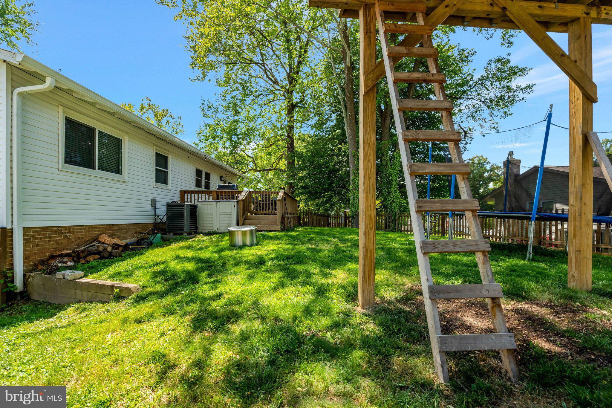 7212 Galgate Drive Springfield, VA 22153 - Photo 32 of 39 a backyard of a house with plants and outdoor seating