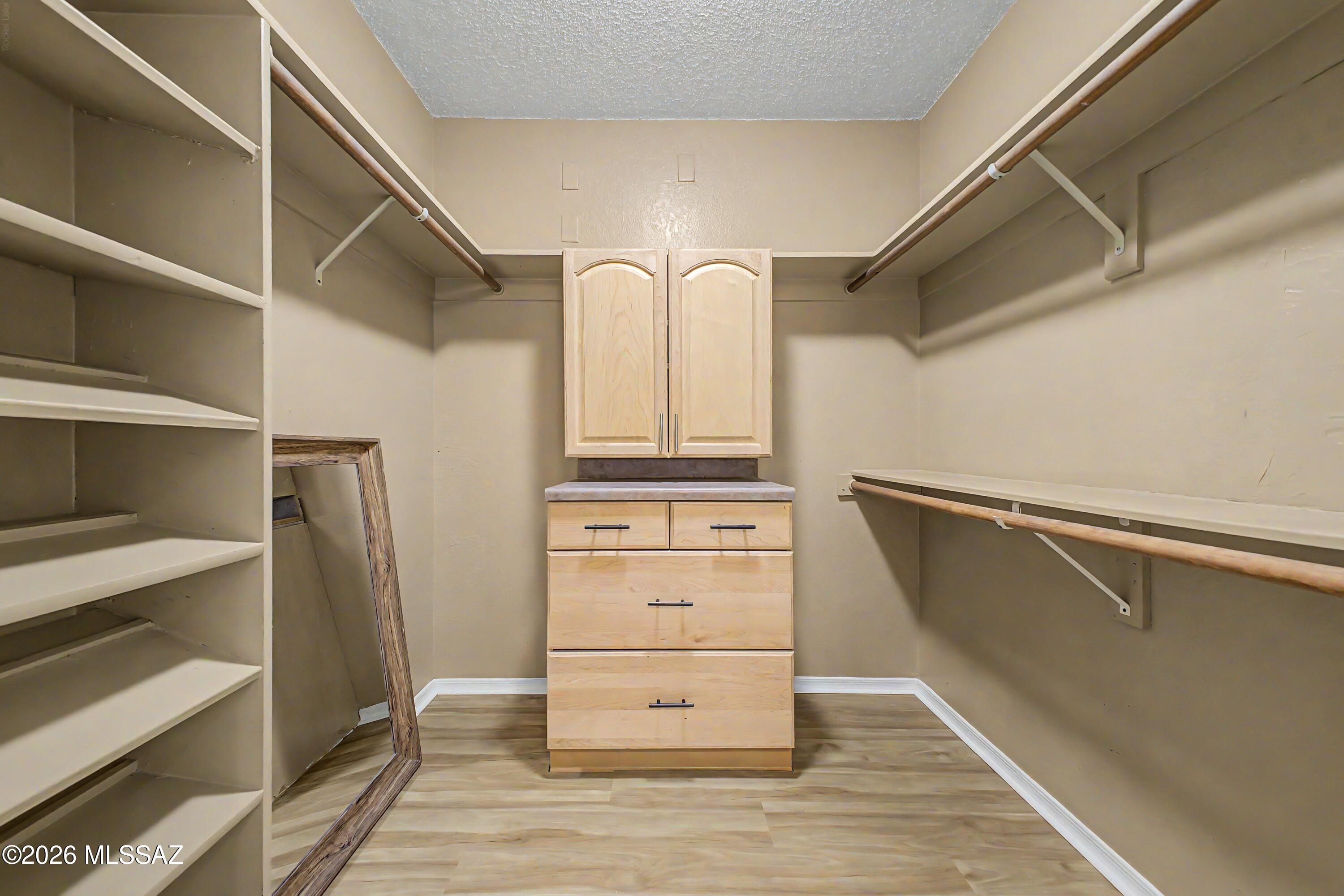 3781 East Edison Street Tucson, AZ 85716 - Photo 20 of 28 a view of walk in closet with empty racks