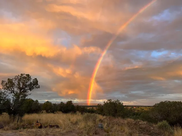 a view of mountain with sunset in background