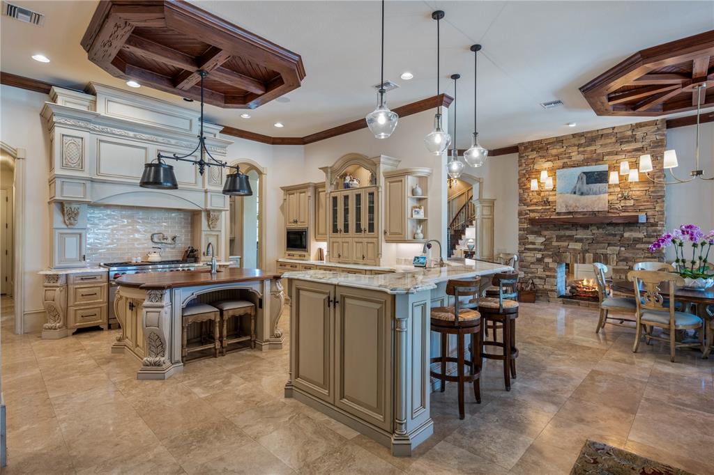 9121 Tibet Pointe Circle Windermere, FL 34786 - Photo 20 of 100 a kitchen with stainless steel appliances granite countertop a stove a sink a dining table and chairs with wooden floor