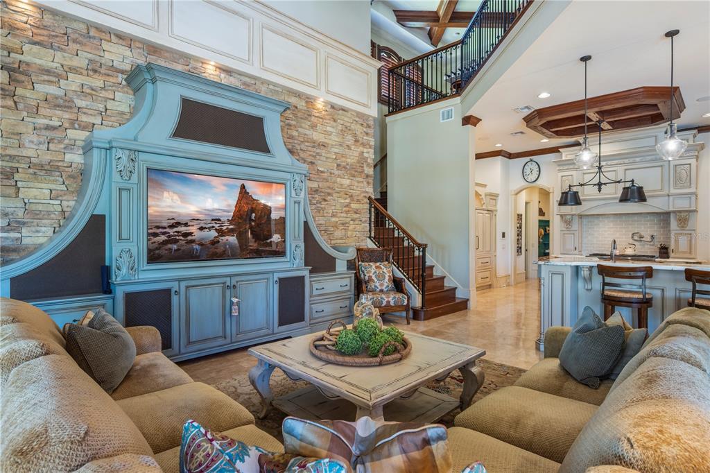 9121 Tibet Pointe Circle Windermere, FL 34786 - Photo 27 of 100 a living room with furniture a flat screen tv and a fireplace