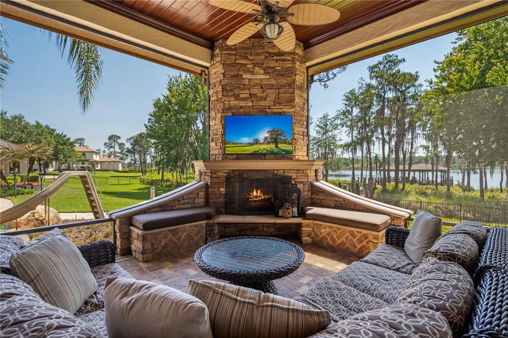 9121 Tibet Pointe Circle Windermere, FL 34786 - Photo 38 of 100 a living room with furniture a flat screen tv and a floor to ceiling window