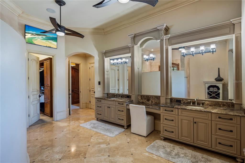 9121 Tibet Pointe Circle Windermere, FL 34786 - Photo 45 of 100 a bathroom with a granite countertop sink a mirror a vanity and a shower