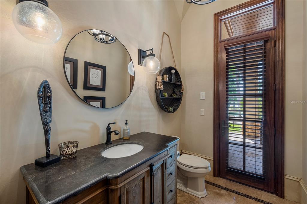 9121 Tibet Pointe Circle Windermere, FL 34786 - Photo 46 of 100 a bathroom with a toilet a sink and mirror
