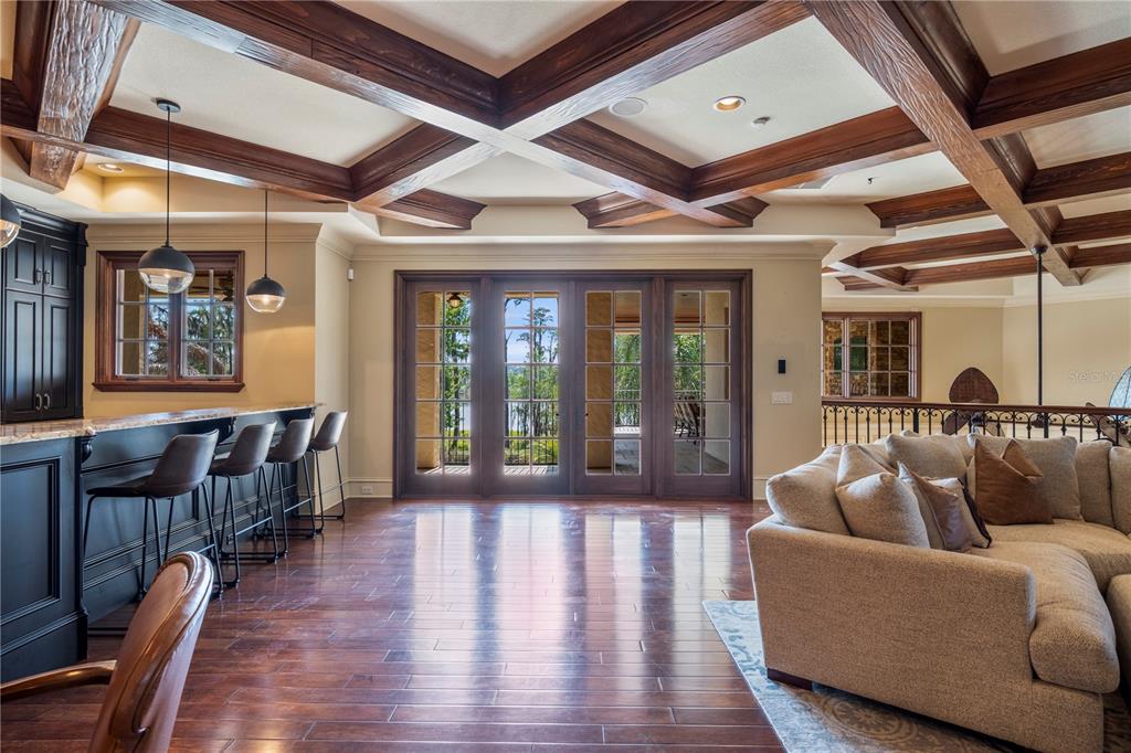 9121 Tibet Pointe Circle Windermere, FL 34786 - Photo 49 of 100 a living room with furniture ceiling fan and a wooden floor