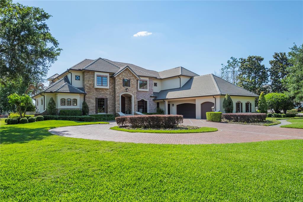 9121 Tibet Pointe Circle Windermere, FL 34786 - Photo 6 of 100 a front view of house with yard and green space