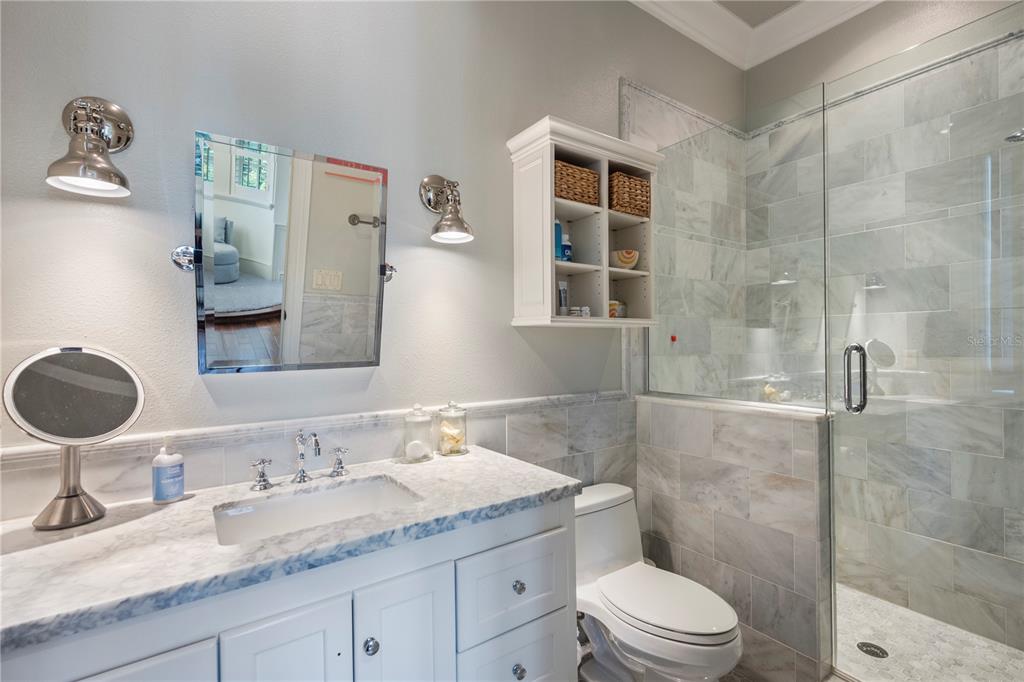 9121 Tibet Pointe Circle Windermere, FL 34786 - Photo 63 of 100 a bathroom with a granite countertop sink toilet a mirror and shower