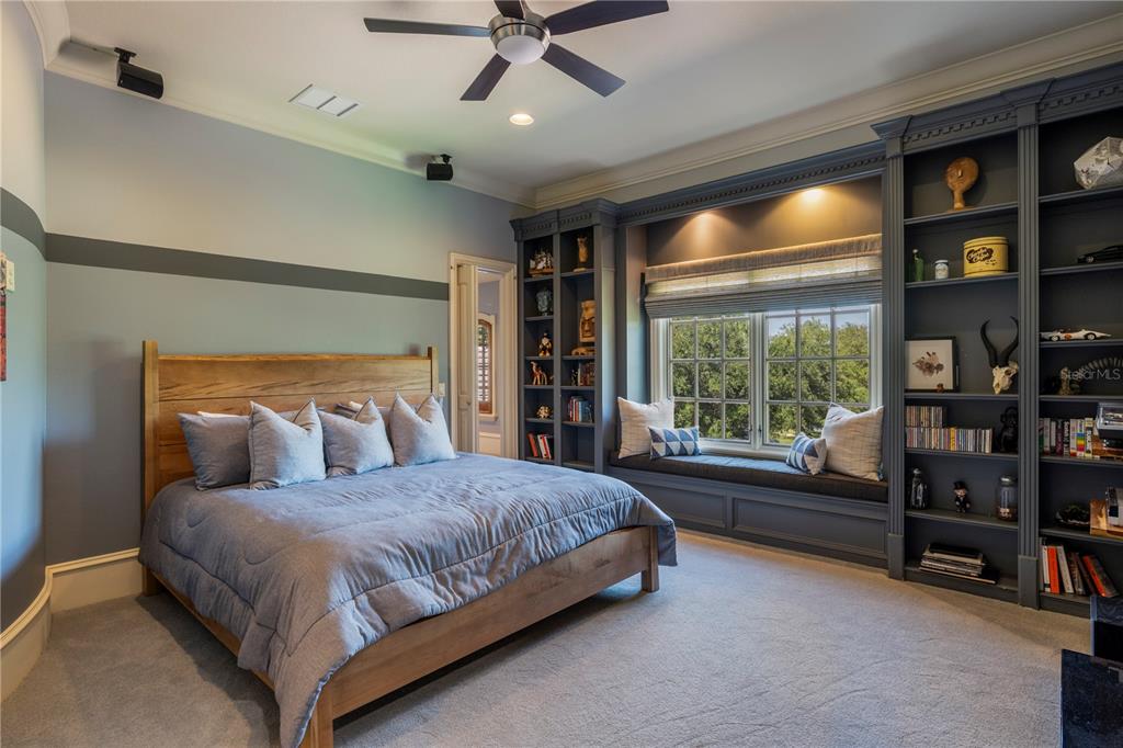9121 Tibet Pointe Circle Windermere, FL 34786 - Photo 65 of 100 a bedroom with a large bed and a book shelf