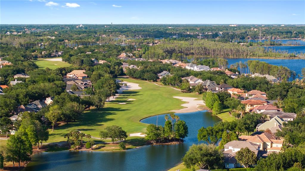 9121 Tibet Pointe Circle Windermere, FL 34786 - Photo 79 of 100 an aerial view of lake residential houses with outdoor space and swimming pool