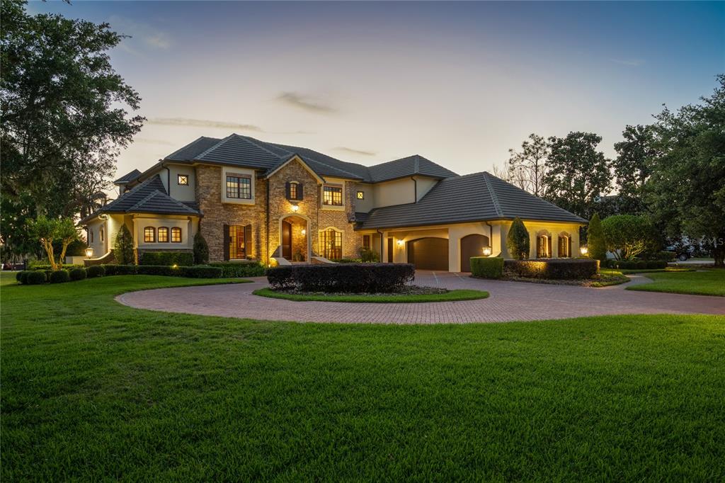 9121 Tibet Pointe Circle Windermere, FL 34786 - Photo 83 of 100 a front view of a house with a yard