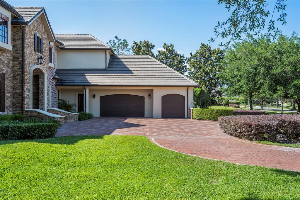 9121 Tibet Pointe Circle Windermere, FL 34786 - Photo 85 of 100 a front view of a house with a yard and garage