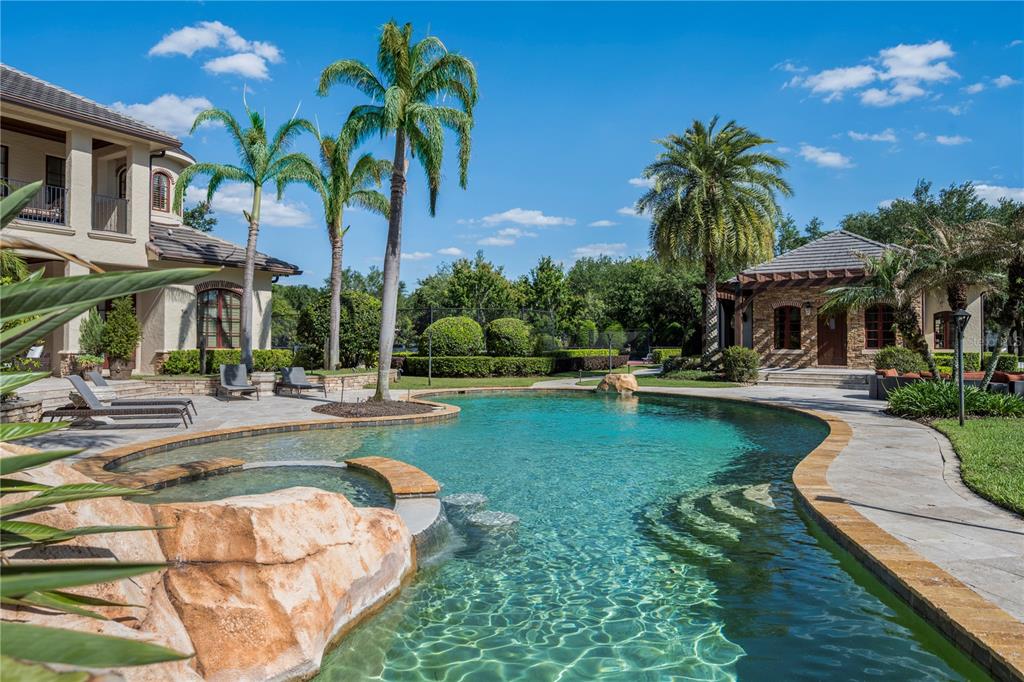 9121 Tibet Pointe Circle Windermere, FL 34786 - Photo 100 of 100 a view of a swimming pool with a garden and patio