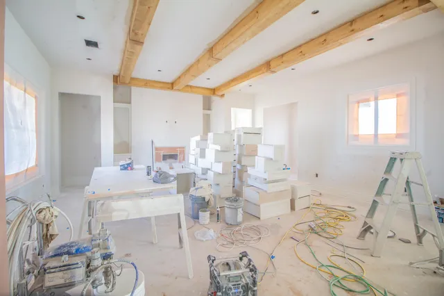 a large room with lots of white furniture