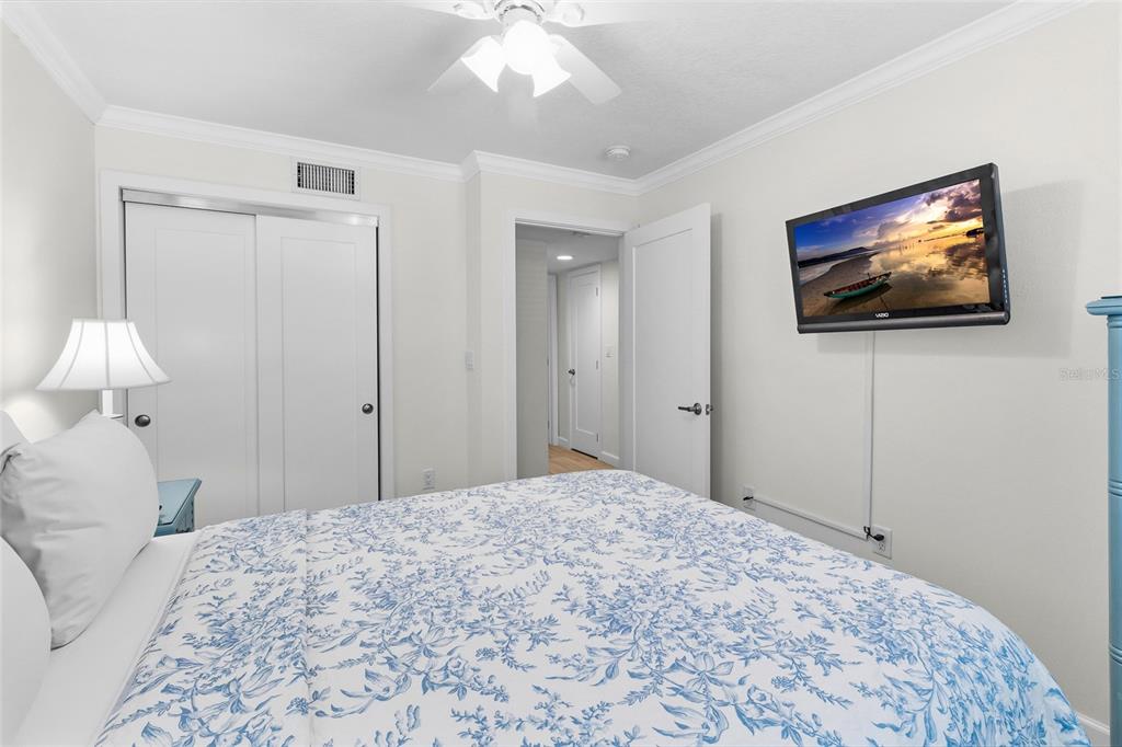 19417 Gulf Boulevard, Unit C109 Indian Rocks Beach, FL 33785 - Photo 14 of 48 a bedroom with a bed and a painting on the wall