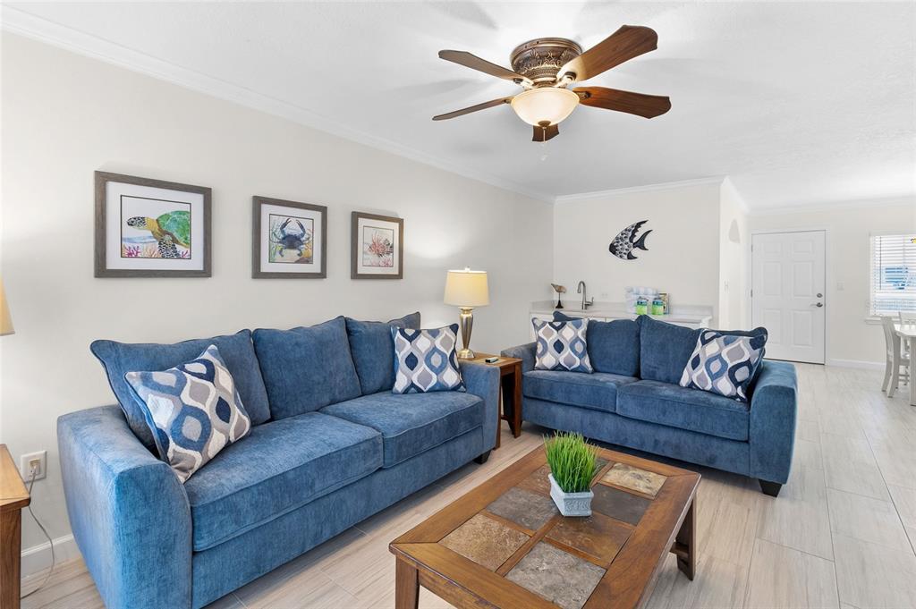 19417 Gulf Boulevard, Unit C109 Indian Rocks Beach, FL 33785 - Photo 17 of 48 a living room with couches and a coffee table