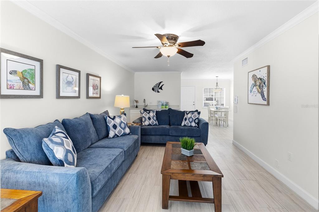 19417 Gulf Boulevard, Unit C109 Indian Rocks Beach, FL 33785 - Photo 18 of 48 a living room with furniture and a wooden floor