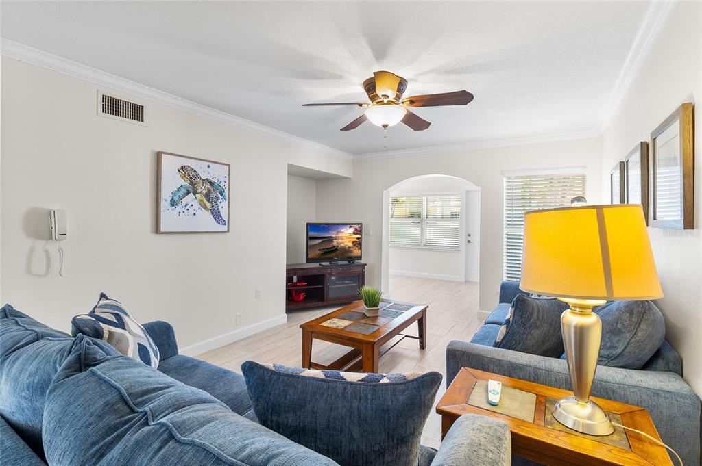19417 Gulf Boulevard, Unit C109 Indian Rocks Beach, FL 33785 - Photo 20 of 48 a living room with furniture and a flat screen tv