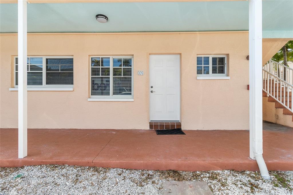 19417 Gulf Boulevard, Unit C109 Indian Rocks Beach, FL 33785 - Photo 2 of 48 a view of an empty room with wooden floor and a window