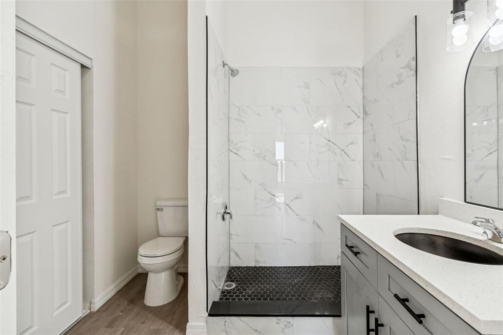 119 Winchester Lane Haines City, FL 33844 - Photo 12 of 24 a bathroom with a sink a toilet and a shower