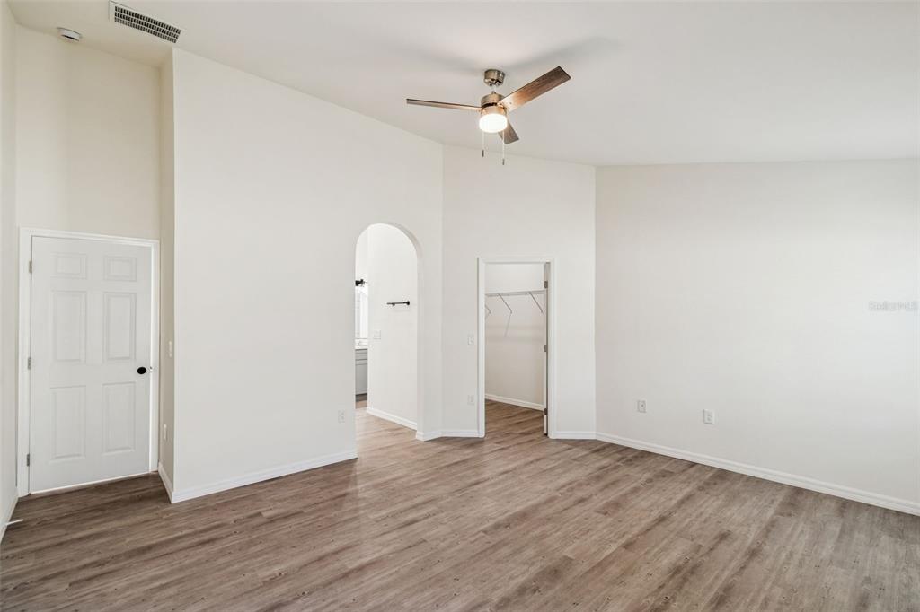 119 Winchester Lane Haines City, FL 33844 - Photo 14 of 24 an empty room with wooden floor and ceiling fan