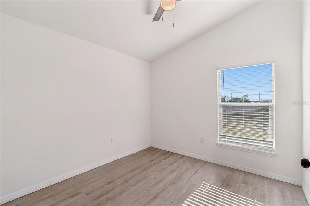 119 Winchester Lane Haines City, FL 33844 - Photo 17 of 24 a view of an empty room with wooden floor and a window