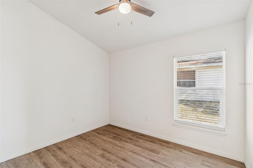 119 Winchester Lane Haines City, FL 33844 - Photo 19 of 24 an empty room with a window and a ceiling fan