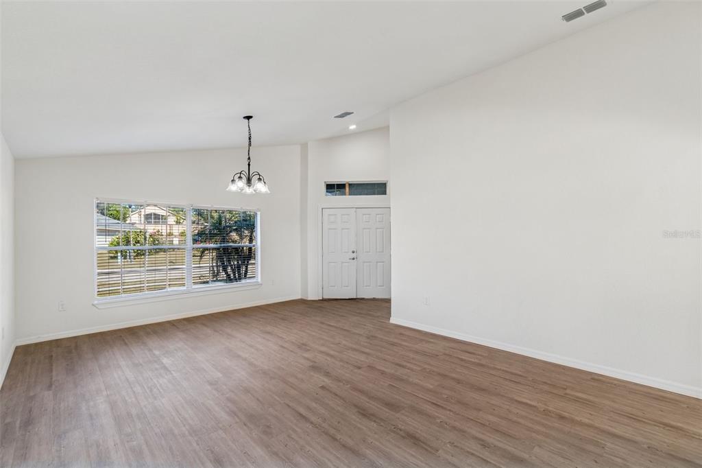 119 Winchester Lane Haines City, FL 33844 - Photo 2 of 24 an empty room with wooden floor and a window