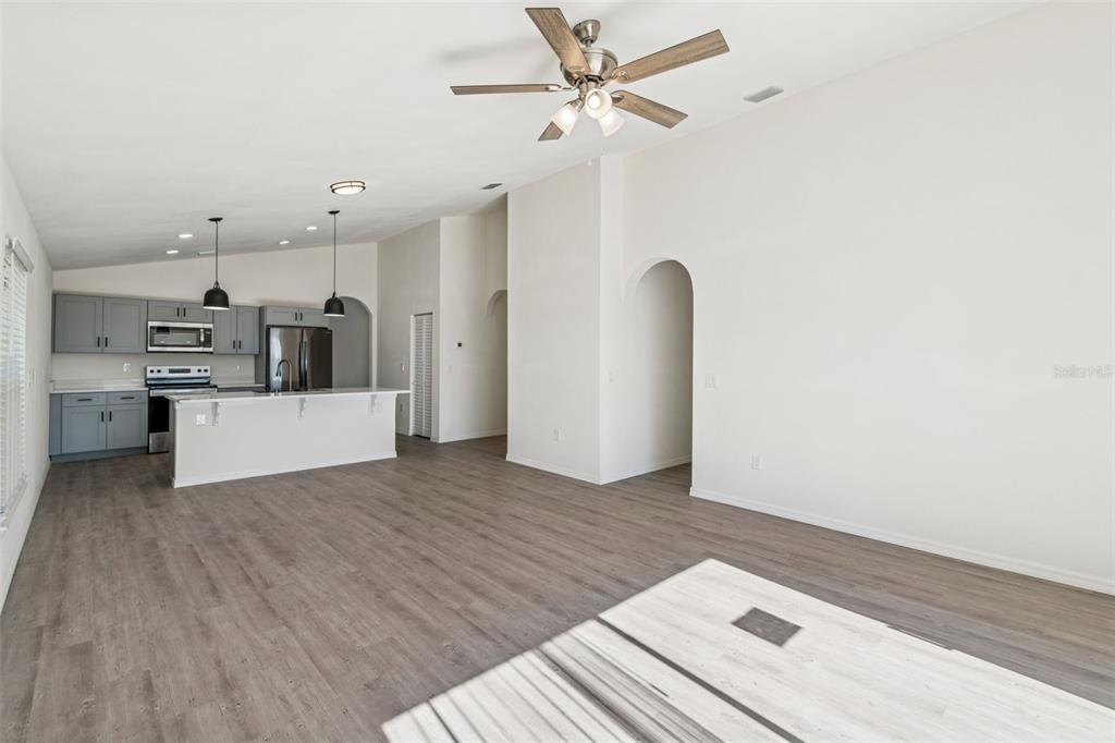 119 Winchester Lane Haines City, FL 33844 - Photo 8 of 24 a view of empty room with wooden floor and ceiling fan
