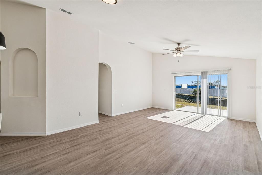 119 Winchester Lane Haines City, FL 33844 - Photo 9 of 24 a view of an empty room with wooden floor