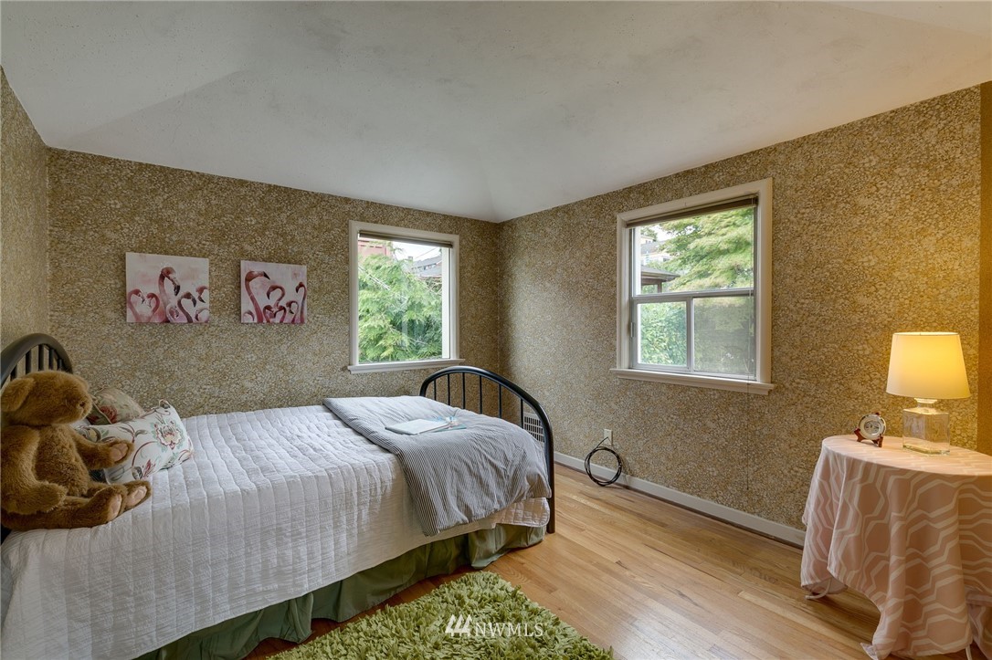 2602 29th Avenue West Seattle, WA 98199 - Photo 17 of 40 a bedroom with a bed and wooden floor