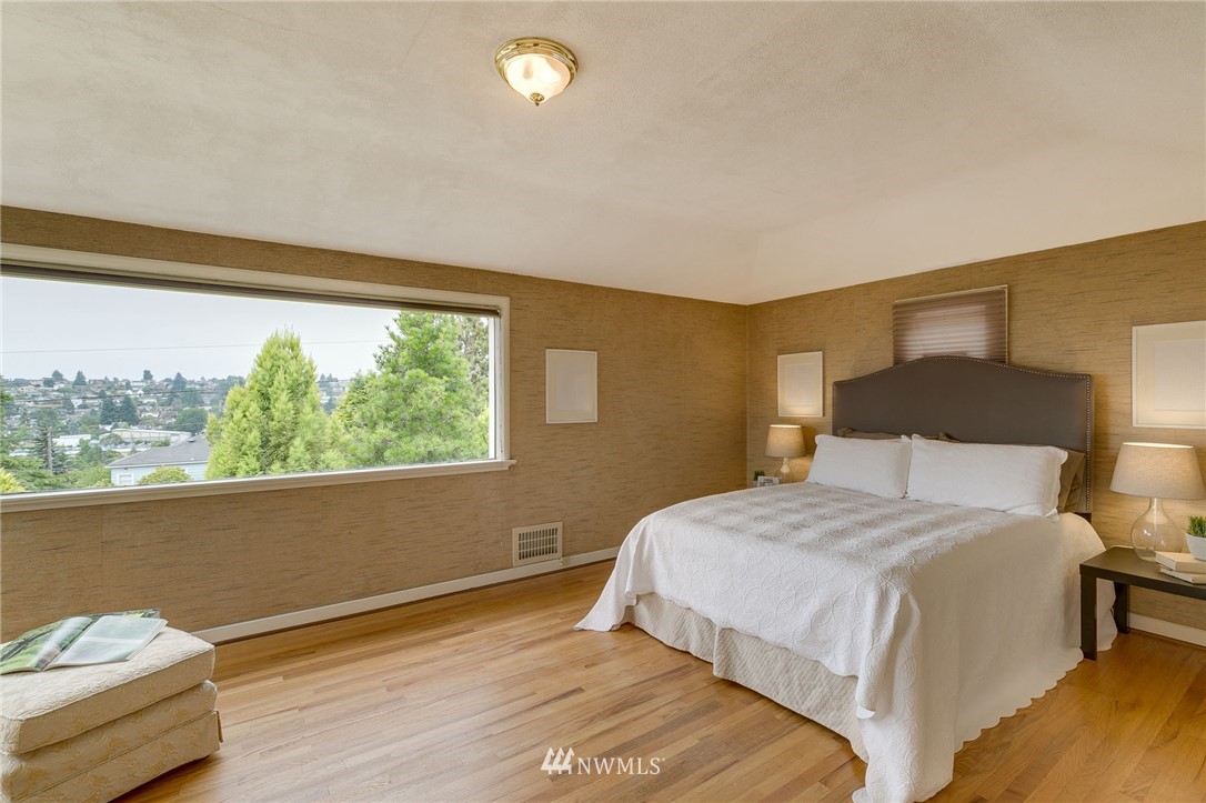 2602 29th Avenue West Seattle, WA 98199 - Photo 19 of 40 a bedroom with a bed and a large window