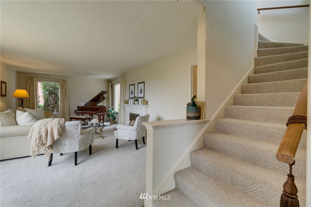 2602 29th Avenue West Seattle, WA 98199 - Photo 4 of 40 a living room with furniture and a chandelier