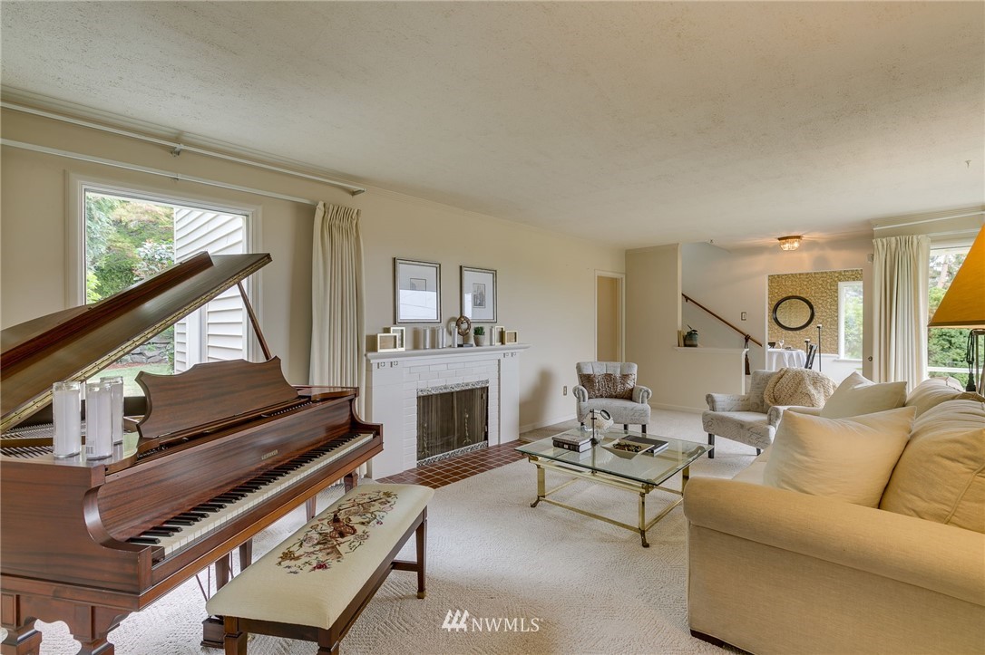 2602 29th Avenue West Seattle, WA 98199 - Photo 6 of 40 a living room with furniture a fireplace and a window