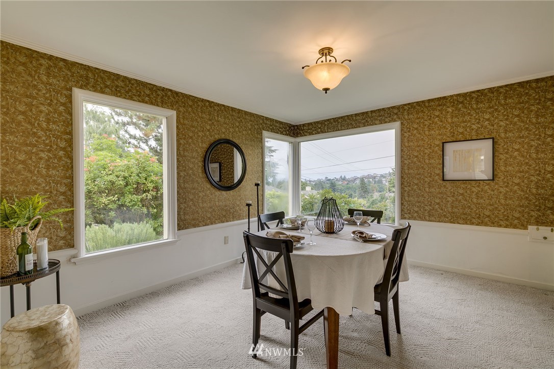 2602 29th Avenue West Seattle, WA 98199 - Photo 7 of 40 a view of a dining room with furniture window and outside view