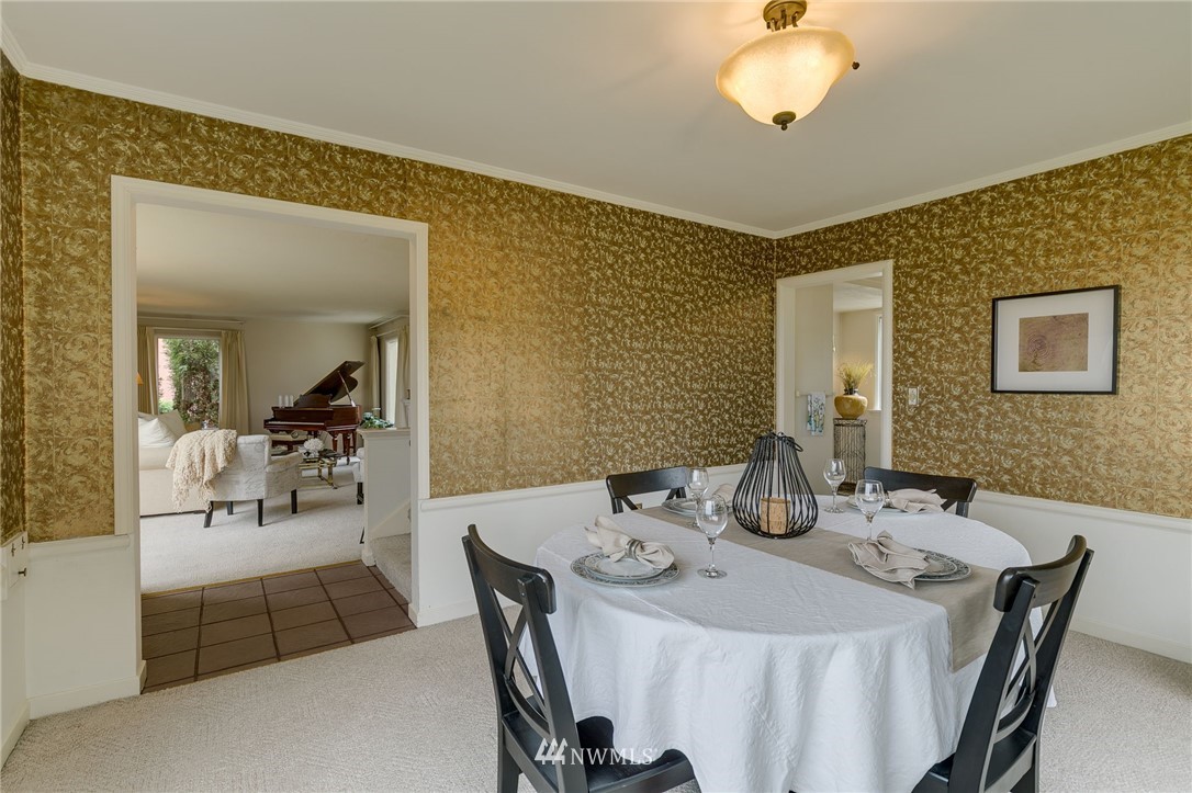 2602 29th Avenue West Seattle, WA 98199 - Photo 8 of 40 a view of a dining room with furniture and chandelier